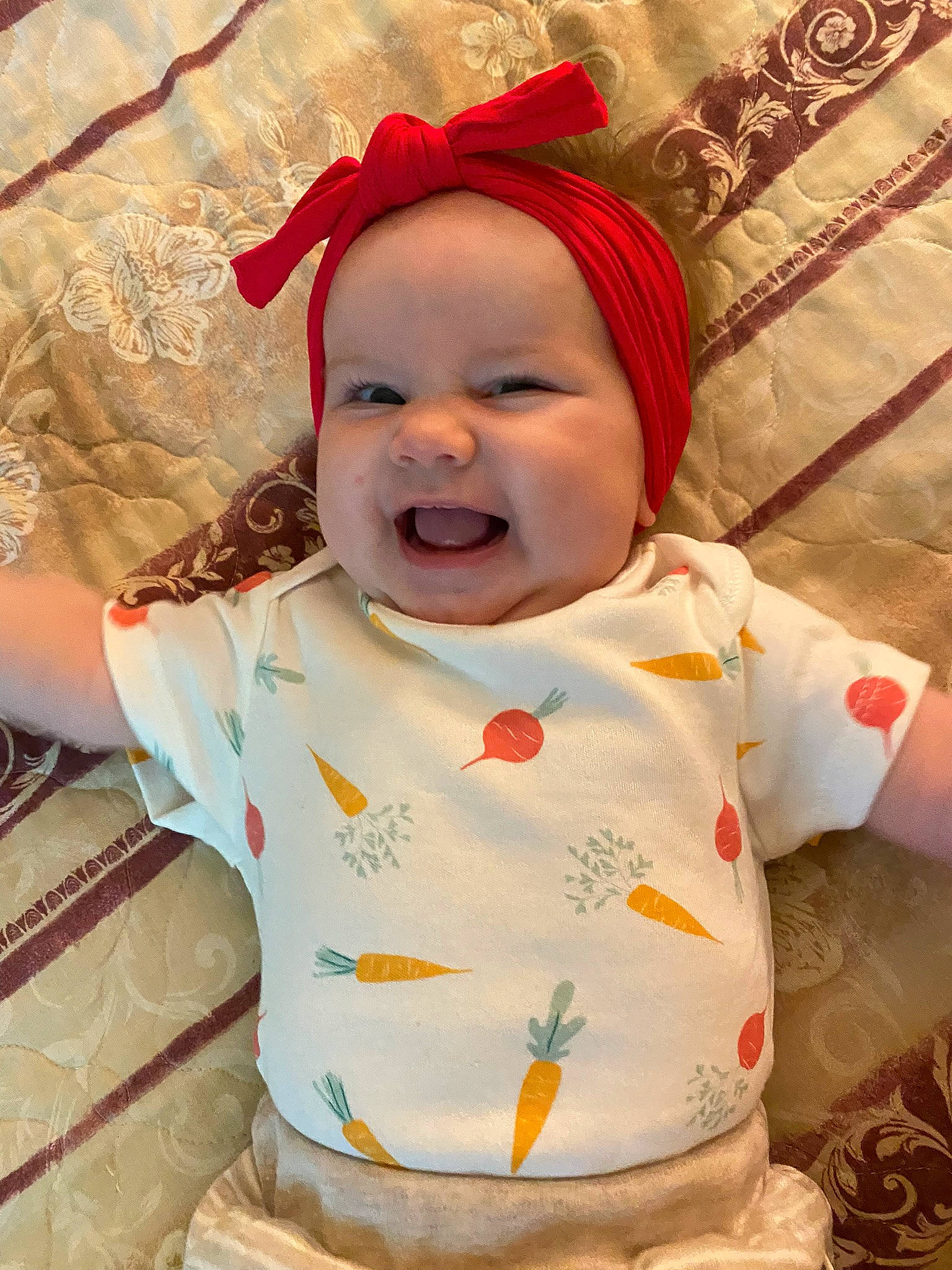 Zoey joined the competition — help win amazing prizes! baby, baby_laughing, baby_toddler_clothing, cheek, child, comfort, face, facial_expression, fun, happy, head, headwear, lip, mouth, orange, pattern, person, pink, skin, sleeve