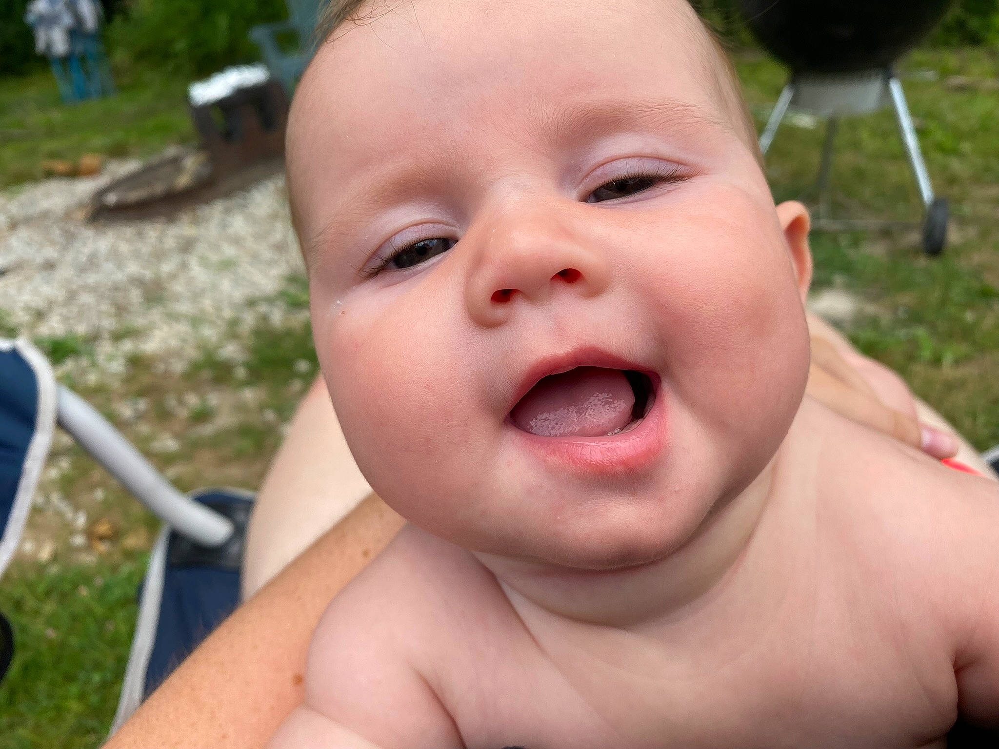 Zoey is registered to the contest to win money with this photo: baby, cheek, chin, eyebrow, eyelash, fun, gesture, grass, happy, iris, leisure, lip, mouth, nose, person, plant, skin, smile, summer, toddler