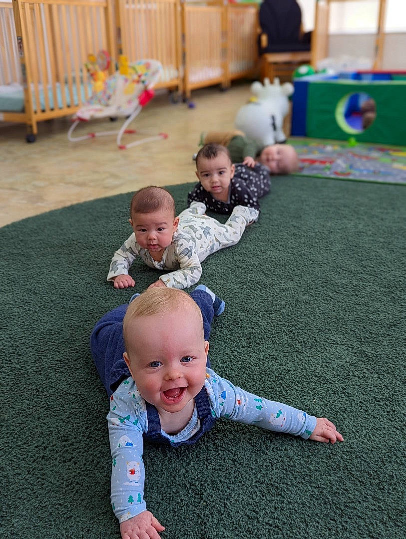 Bobby joined the competition — help win amazing prizes! baby, baby_toddler_clothing, carpet, child, event, facial_expression, floor, flooring, fun, grass, happy, head, lawn, leisure, person, room, sitting, sleeve, smile, toddler