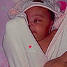 Ymir is registered to the contest to win money with this photo: baby, blanket, pink, towel, animal_hood, face, infant, cute, wrapped, resting, hand, soft, pattern, flamingo, sleepwear, cozy, child, portrait, indoors, expression