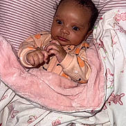Alivia joined the competition — help win amazing prizes! baby, blanket, child, clothing, cute, fabric, face, hand, indoors, infant, newborn, onesie, pattern, person, pink, portrait, sleepwear, soft, white, wrapped