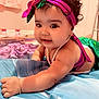 Naisha is registered to the contest to win money with this photo: baby, blanket, bracelet, child, closeup, costume, curly_hair, cute, happy, headband, indoor, infant, lying_down, mermaid_costume, pearl_necklace, person, playful, portrait, smiling, toddler