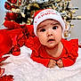 Naisha is registered to the contest to win money with this photo: baby, infant, christmas, holiday, festive, red_clothing, hat, my_first_christmas, ornaments, christmas_tree, decorations, lights, white_blanket, cute, portrait, indoors, celebration, toddler, holiday_spirit, seasonal