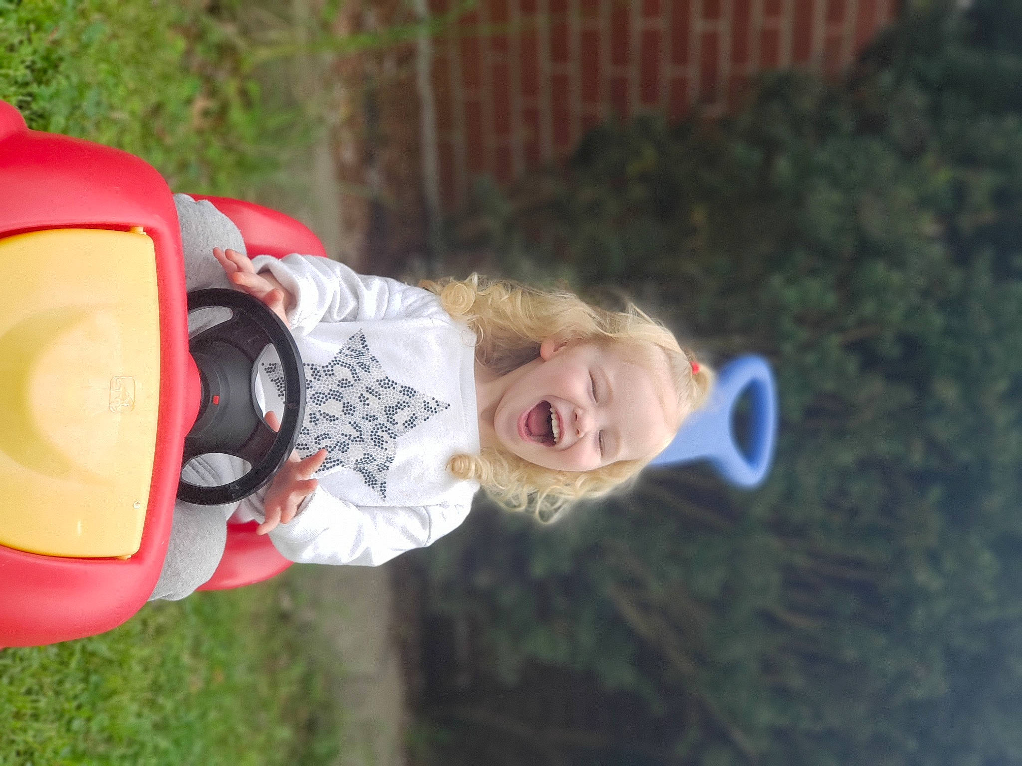 Ellie Mae is registered to the contest to win money with this photo: baby, child, fun, grass, happy, hat, lawn_ornament, leisure, person, personal_protective_equipment, plant, recreation, smile, toddler, toy, tree, yard