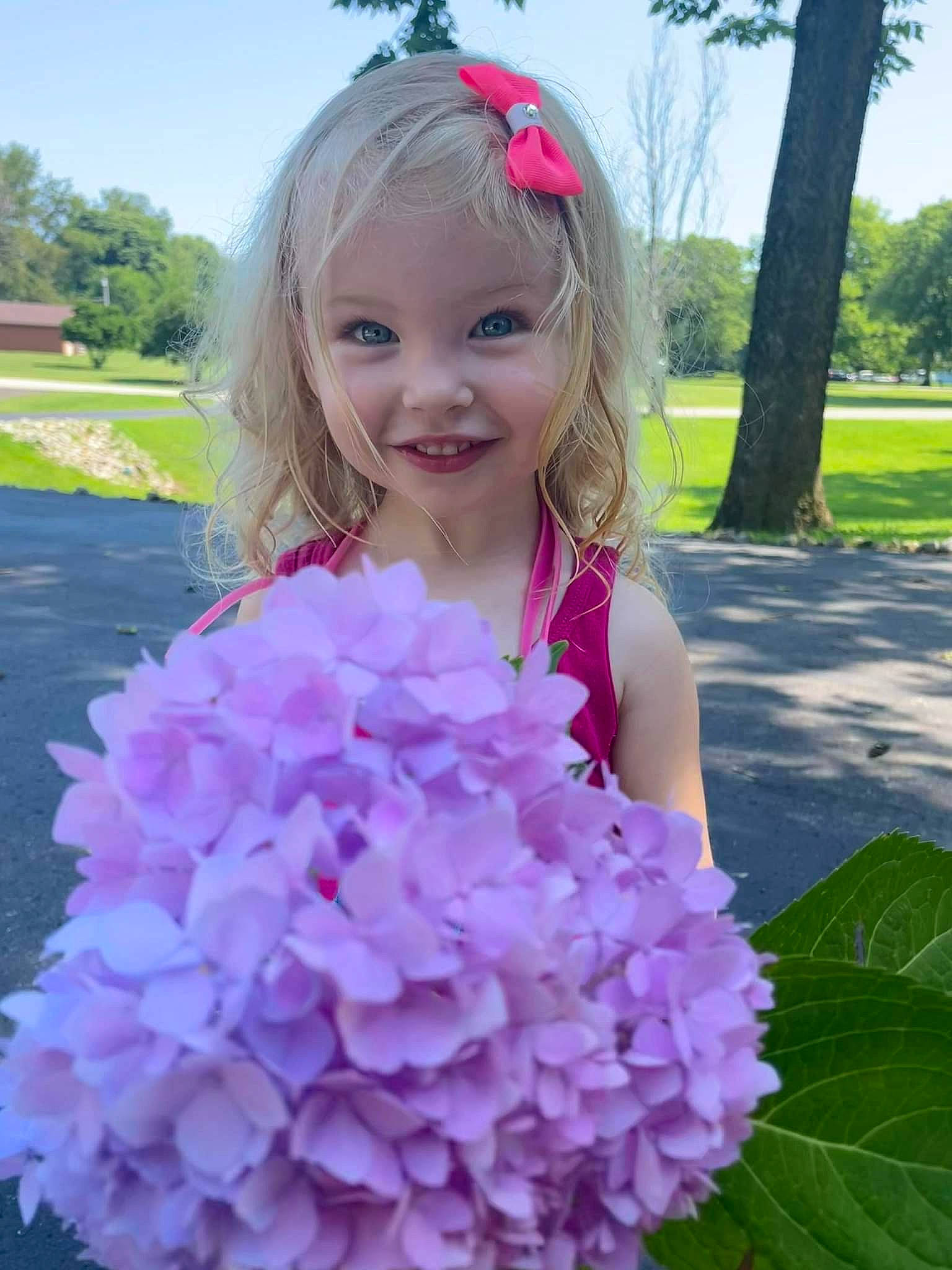 Ellie Mae joined the competition — help win amazing prizes! annual_plant, beauty, botany, dress, flower, grass, groundcover, happy, joy, magenta, person, petal, photograph, pink, plant, purple, sky, smile, summer, toddler