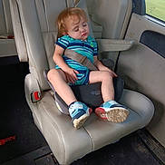 Alvin is registered to the contest to win money with this photo: blue_shoes, bottle, car, car_seat, child, daylight, indoors, leather_seat, nap, portrait, red_hair, road_trip, seatbelt, sleeping, sneakers, striped_shirt, toddler, travel, vehicle, window