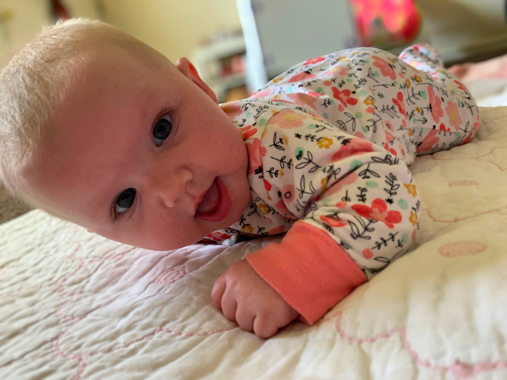 Emberly is registered to the contest to win money with this photo: baby, baby_toddler_clothing, cheek, child, comfort, flooring, happy, iris, linens, lip, mammal, mouth, nose, person, room, sitting, skin, sleeve, smile, toddler