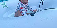 Brielle is registered to the contest to win money with this photo: toddler, child, swimming_pool, inflatable_float, water, summer, outdoor, happy, sitting, swimsuit, excitement, water_droplets, recreation, leisure, people, adult, chair, fence, plant, daytime