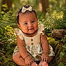 Priyah is registered to the contest to win money with this photo: baby, child, forest, nature, greenery, smile, dress, bow, outdoor, sunlight, foliage, grass, moss, cute, portrait, sitting, infant, happy, hands, feet