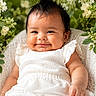 baby, baby_girl, child, cozy, cute, face, flowers, greenery, hair, happy, infant, nature, outdoor, plant, portrait, sitting, skin, smile, white_clothing, young