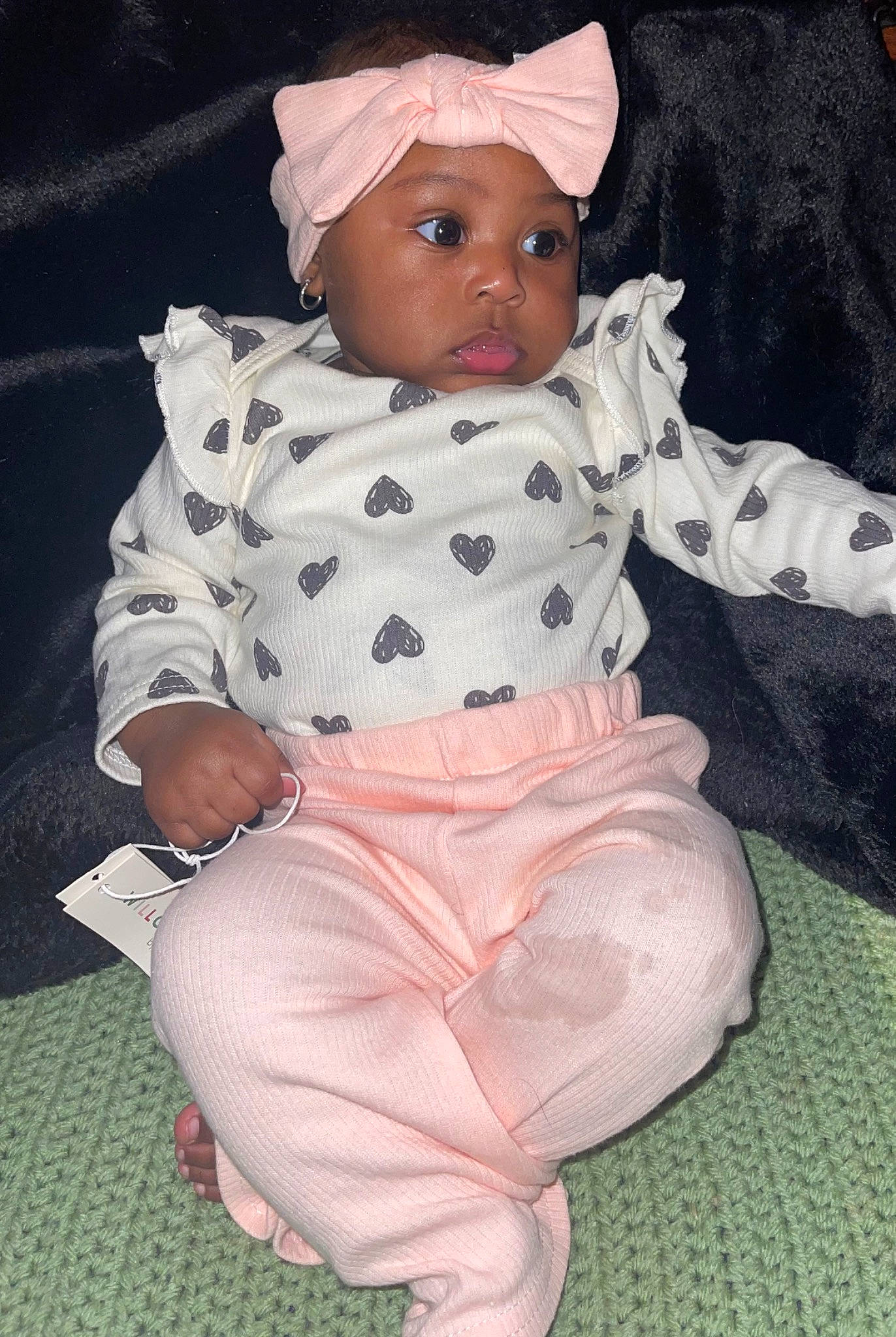 Alani is registered to the contest to win money with this photo: baby, baby_products, baby_toddler_clothing, cap, cheek, child, christmas, comfort, costume_hat, headwear, lap, linens, pattern, person, pink, sitting, sleeve, textile, toddler