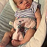 Wynter is registered to the contest to win money with this photo: baby, baby_seat, child, comfort, cushion, cute, face, feet, head_support, indoor, infant, minnie_mouse, newborn, onesie, person, plush, purple_stripes, relaxed, resting, soft_toy
