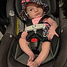 baby, baby_accessory, car_safety, car_seat, child, cute, face, hat, headwear, indoor, infant, looking, newborn, padded_seat, person, pink_clothing, seatbelt, secure, sitting, straps