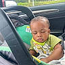 baby, car_seat, sleeping, child, infant, clothing, blanket, car_interior, window, rain_drops, seatbelt, cute, peaceful, young_child, portrait, toddler, green, black, daylight, vehicle