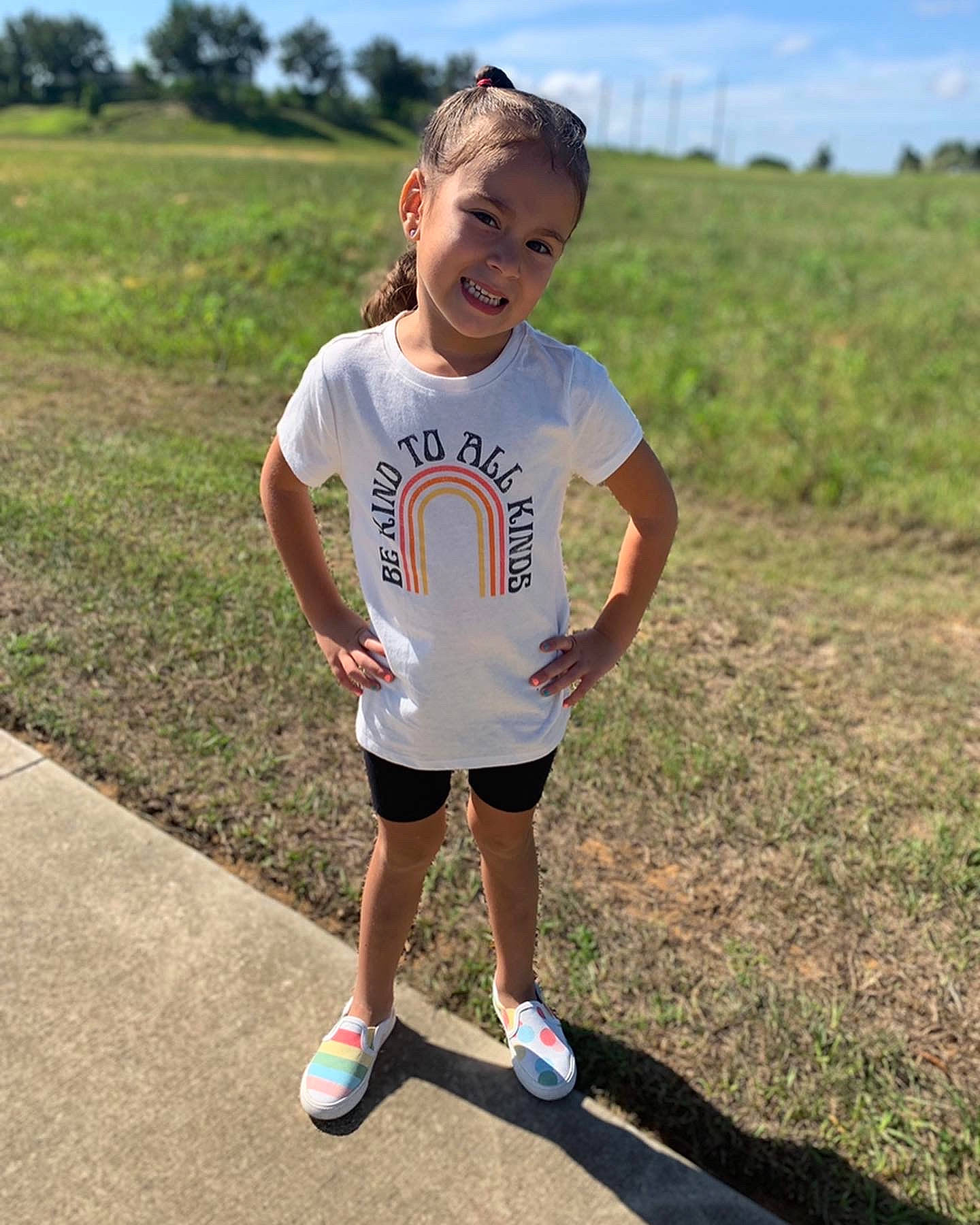 Micaela is registered to the contest to win money with this photo: asphalt, fun, grass, grassland, happy, human_leg, joy, knee, landscape, leisure, people_in_nature, person, plant, recreation, running, shorts, sky, sleeve, sneakers, sportswear