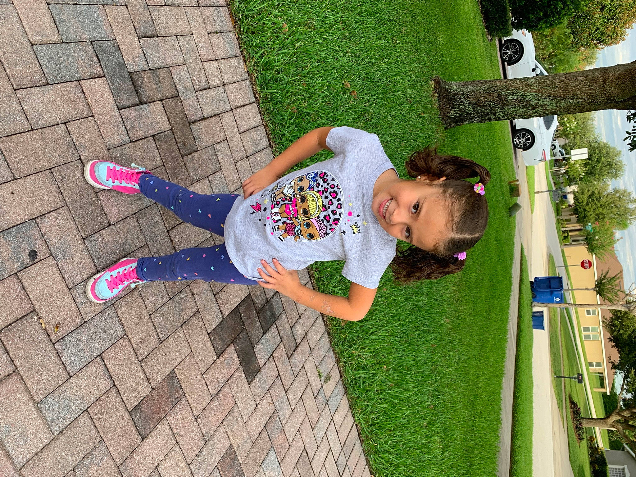 Micaela is registered to the contest to win money with this photo: child, city, flooring, fun, grass, green, happy, human_settlement, joy, leg, leisure, pattern, people_in_nature, person, plant, public_space, recreation, road_surface, sidewalk, t_shirt