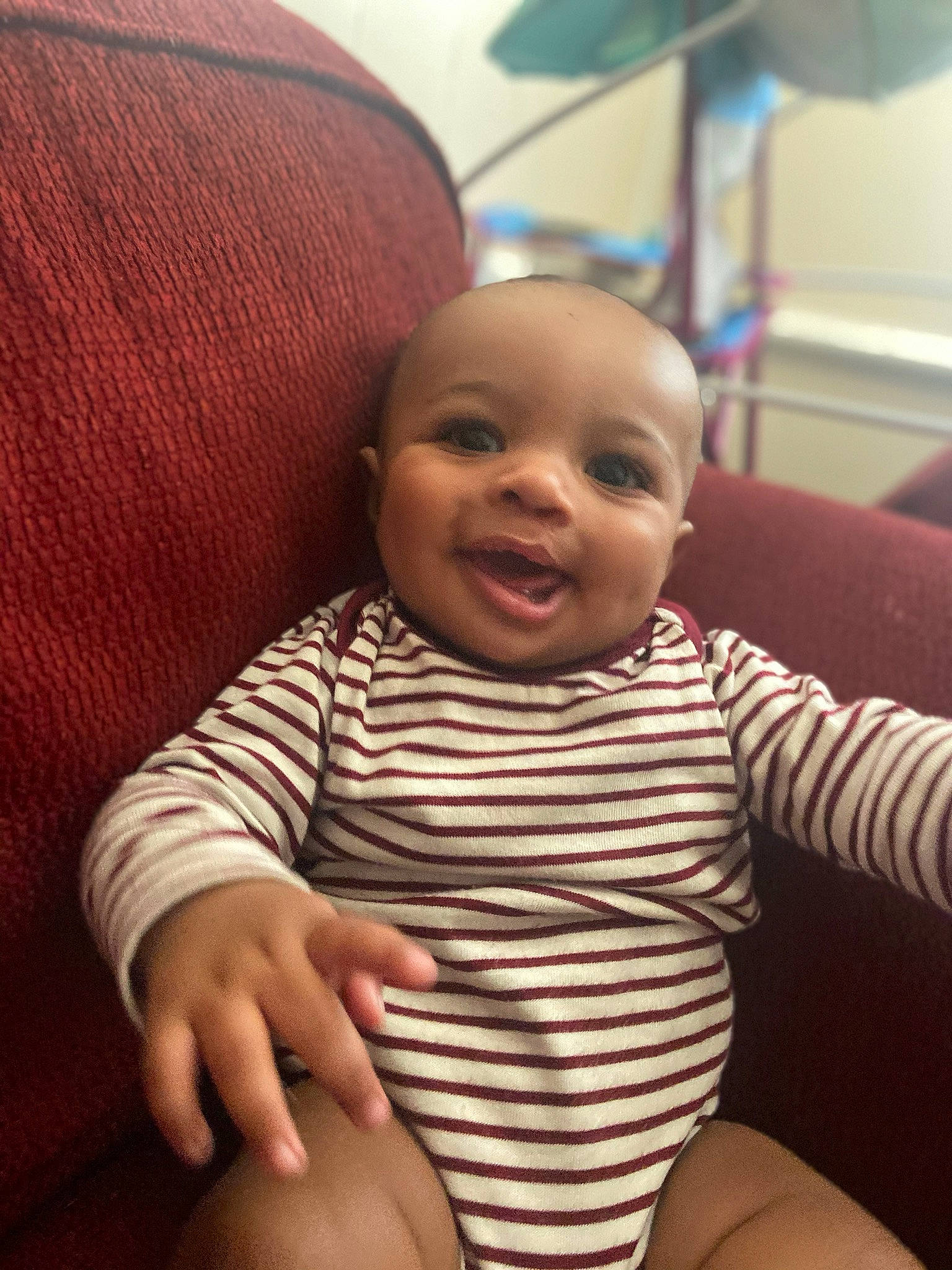 Dominik is registered to the contest to win money with this photo: arm, baby, cheek, child, face, finger, head, leg, mouth, person, sitting, skin, smile, toddler