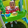 baby, child, outdoor, grass, sunlight, playground, toys, jumper, green, blue, red, happy, smiling, person, infant, nature, daylight, clothing, feet, face