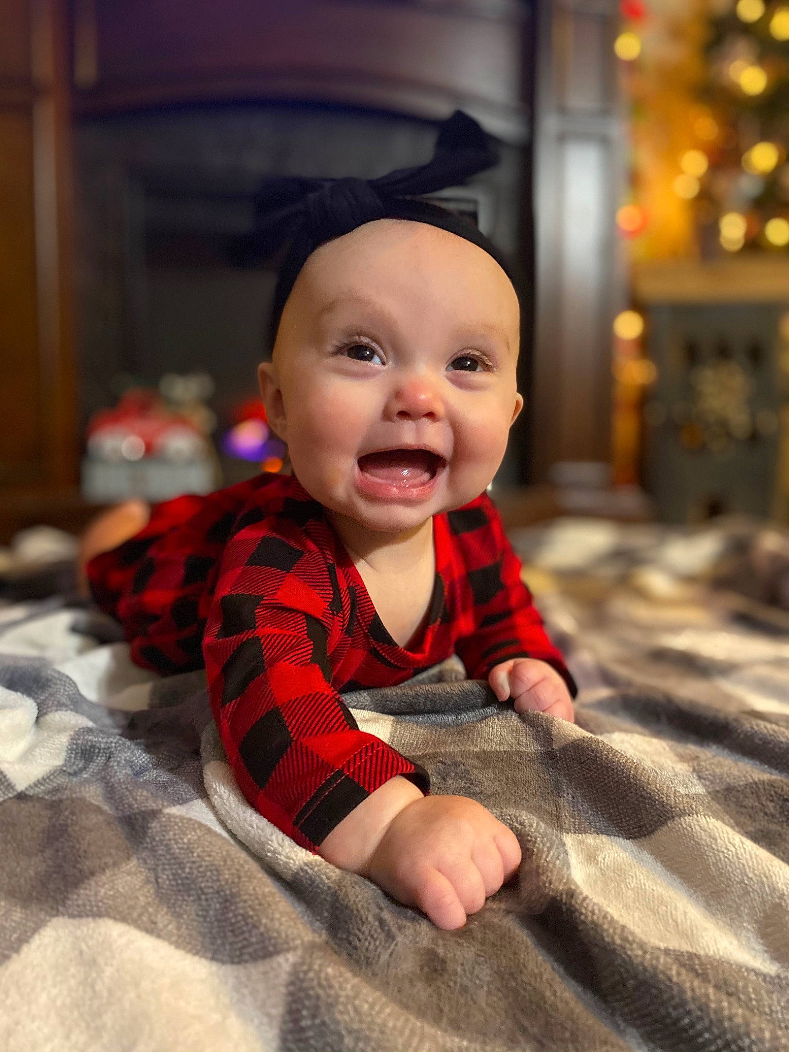 Helena is registered to the contest to win money with this photo: baby, baby_laughing, baby_toddler_clothing, blanket, child, crawling, ear, eye, headwear, laugh, linens, mouth, person, plaid, pleased, textile, toddler, tongue, tummy_time