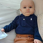 Alèzïo participe au concours pour gagner de l'argent avec cette photo : baby, child, infant, face, clothing, pants, long_sleeve, polo_shirt, couch, furniture, indoor, person, casual, light, skin, hand, relaxed, seated, young, portrait