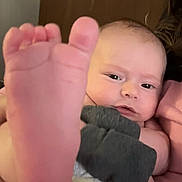 Brayden joined the competition — help win amazing prizes! baby, foot, diaper, person, face, hand, video_call, glasses, indoor, expression, skin, clothing, holding, adult, technology, communication, background, door, closeup, family