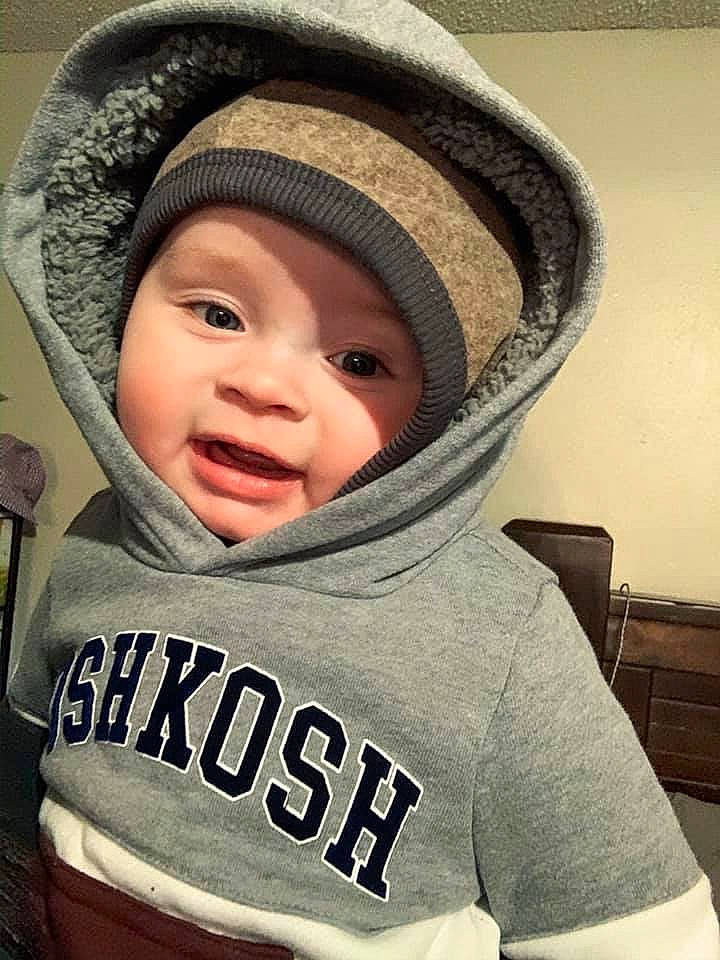 Deegan is registered to the contest to win money with this photo: baby, beanie, cap, cheek, child, clothing, cool, fashion_accessory, hat, head, headgear, headwear, hood, hoodie, knit_cap, outerwear, person, sleeve, smile, toddler