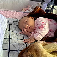 Eleanor joined the competition — help win amazing prizes! baby, sleeping, blanket, bed, quilt, pink_clothing, ladybug_pattern, hand, face, nursery, soft_texture, infant, cozy, rest, indoors, peaceful, child, person, portrait, sleep