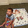 Luis joined the competition — help win amazing prizes! toddler, baby, child, carpet, toy, stuffed_animal, quilt, butterfly_pattern, indoor, floor, clothing, barefoot, headband, smile, sitting, lying_down, happy, playful, infant, brother_sister