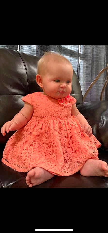 Kinsley Morgan is registered to the contest to win money with this photo: baby, baby_toddler_clothing, beauty, cheek, child, comfort, couch, day_dress, dress, eye, facial_expression, hairstyle, iris, lip, one_piece_garment, person, pink, shoulder, skin, sleeve