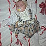 Sienna Mae is registered to the contest to win money with this photo: baby, sleeping, pacifier, headband, bow, dress, plaid, lace, blanket, red_ribbon, white_clothing, tights, cute, infant, child, lying_down, indoors, peaceful, accessory, soft