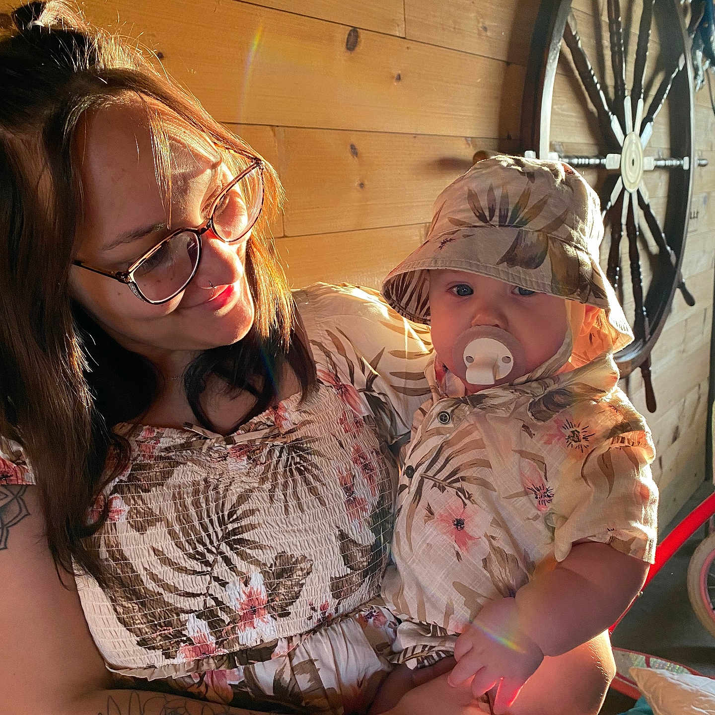 Bodi is registered to the contest to win money with this photo: accessories, adult, baby, clothing, face, female, glasses, hat, head, machine, person, photography, portrait, skin, spoke, sunglasses, t_shirt, tattoo, wheel, woman