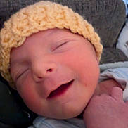 Devon joined the competition — help win amazing prizes! baby, newborn, smiling, hat, knitted_hat, face, hand, sleeping, closeup, infant, cute, peaceful, soft, cozy, portrait, child, newborn_clothing, resting, indoors, warm