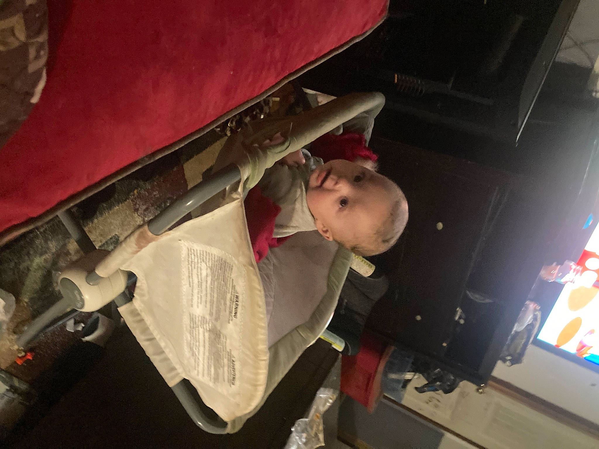 Izayah is registered to the contest to win money with this photo: auto_part, automotive_exterior, bumper, carmine, display_device, elbow, engineering, fun, hat, machine, person, room, toddler, wood