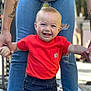 baby, bright_clothing, casual, child, cute, denim, hands, happy, holding_hands, jeans, outdoor, person, portrait, red_shirt, smiling, supporting, tattoo, toddler, walking, young_child