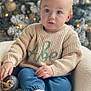 Abel is registered to the contest to win money with this photo: blue_eyes, casual_clothing, chair, child, christmas_tree, cozy, cute, decorative_ball, festive, holiday_decor, indoor, knitwear, ornament, portrait, sitting, soft_lighting, sweater, toddler, white_shoes, young_child