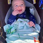 Abel is registered to the contest to win money with this photo: baby, car_seat, blanket, blue_eyes, smiling, happy, child, infant, clothing, hand, seatbelt, sunglasses, indoor, portrait, cute, face, person, cozy, baby_garment, safety
