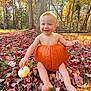 autumn, baby, barefoot, child, cute, fall, forest, grass, holiday, leaves, nature, orange, outdoor, playful, pumpkin, seasonal, smile, sunlight, tree, white_pumpkin