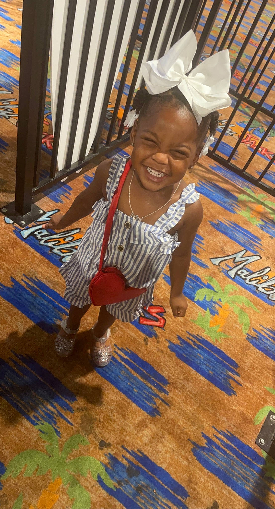 Kamiyah is registered to the contest to win money with this photo: adaptation, art, child, dress, event, flooring, fun, happy, hardwood, joy, leisure, person, sitting, smile, t_shirt, temple, textile, toddler, tribe, water