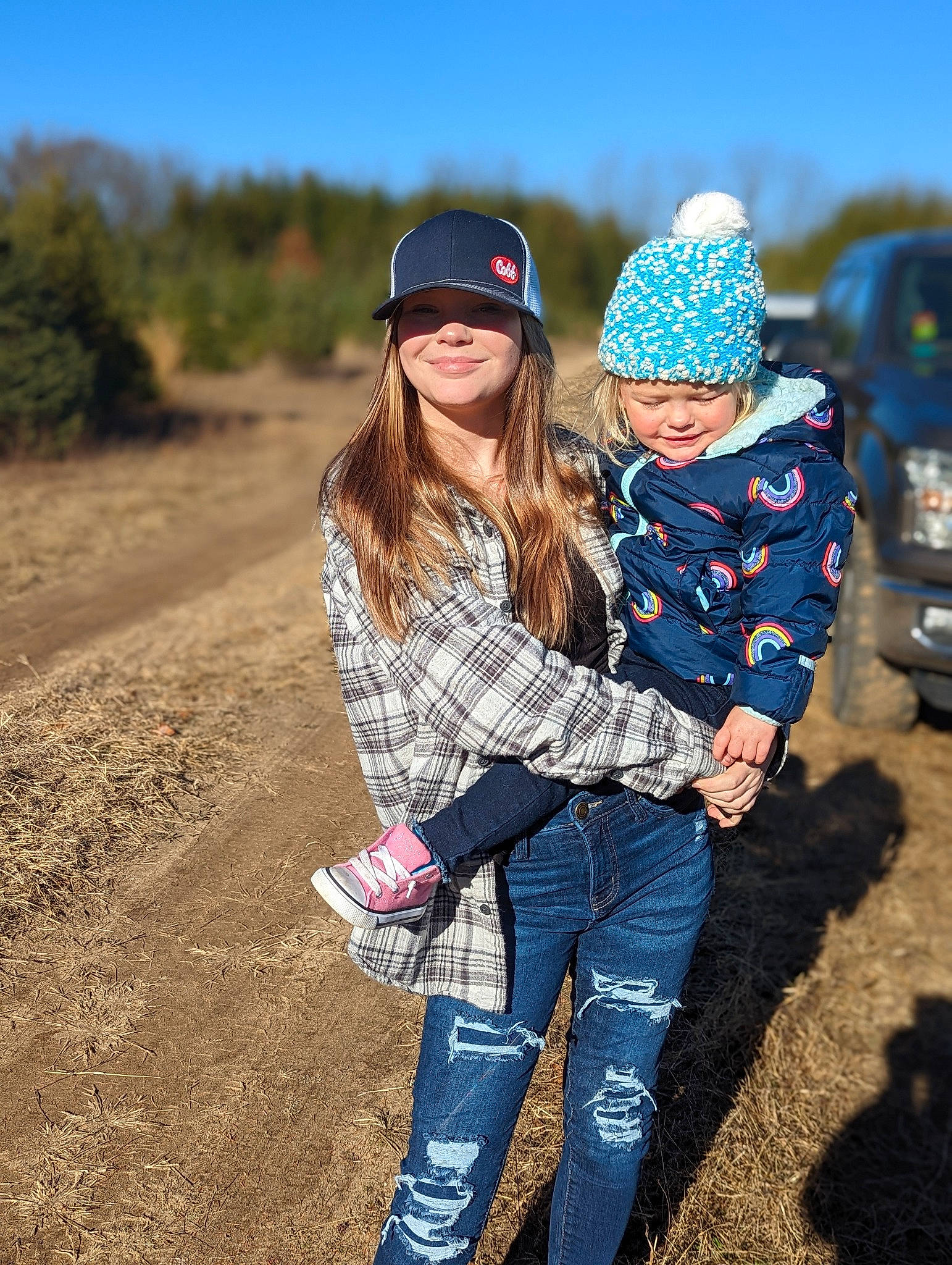 Brenna is registered to the contest to win money with this photo: baseball_cap, cap, cool, eyewear, facial_expression, friendship, fun, grass, hairstyle, happy, headgear, headwear, jeans, joy, landscape, leaf, leisure, people_in_nature, person, plant