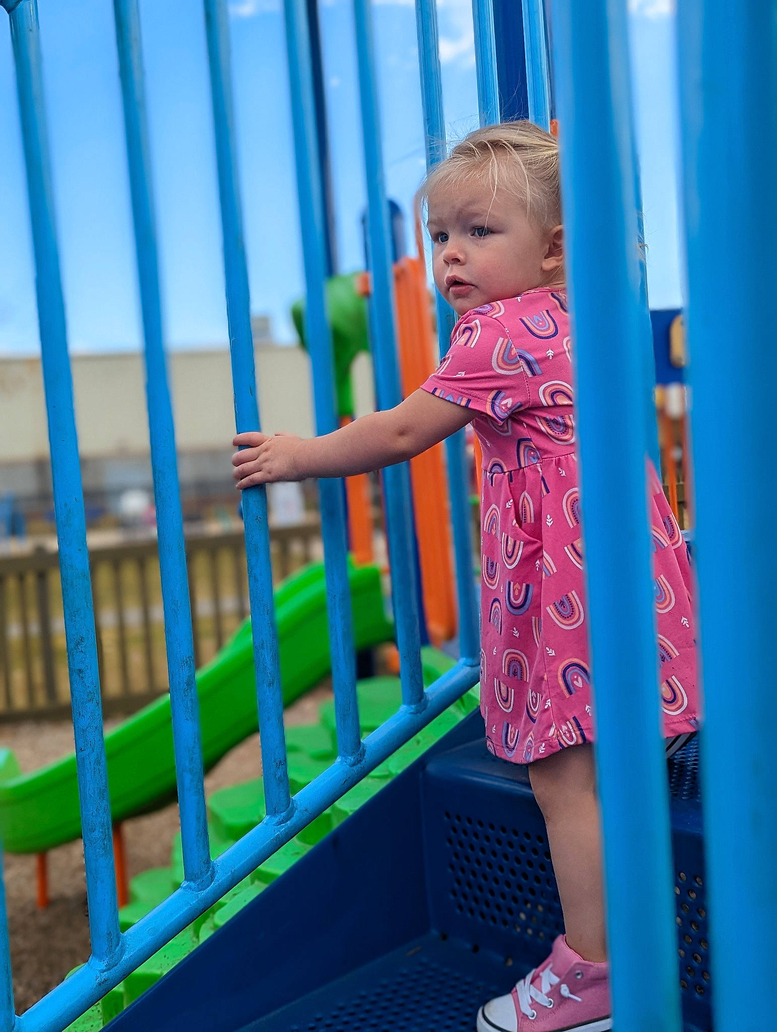 Shiloh is registered to the contest to win money with this photo: azure, baby, baby_toddler_clothing, blue, child, city, electric_blue, fence, fun, happy, human_leg, leisure, magenta, outdoor_play_equipment, pattern, person, play, recreation, sandal, t_shirt