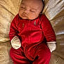 baby, sleeping, red_onesie, mittens, blanket, infant, peaceful, cozy, holiday_theme, cute, child, portrait, soft_lighting, indoors, newborn, resting, warm, comfort, face, cute_baby