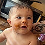 baby, child, messy_face, food, kitchen, microwave, tattoo, arm, wet_skin, curly_hair, indoor, cute, expression, person, portrait, infant, toddler, skin, closeup, holding