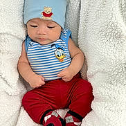 Joab joined the competition — help win amazing prizes! baby, infant, hat, teddy_bear_patch, donald_duck, striped_shirt, red_pants, argyle_socks, blanket, fluffy, cozy, cute, child, clothing, portrait, indoors, resting, hands, feet, comfort