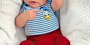 Joab joined the competition — help win amazing prizes! baby, infant, blanket, hat, clothing, striped_shirt, donald_duck, red_pants, socks, cozy, cute, portrait, child, smiling, indoors, soft_texture, warm, casual_wear, cuteness, baby_pose