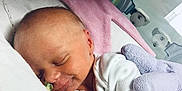 Eilidh is registered to the contest to win money with this photo: newborn, baby, sleeping, infant, blanket, stuffed_animal, hospital, nursery, soft_toy, white_clothing, peaceful, cuddle, bed, head, face, skin, rest, comfort, sleep, child