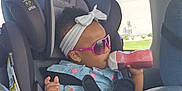 Jayden joined the competition — help win amazing prizes! accessory, baby, bottle, bracelet, car_interior, car_seat, child, clothing, cute, daylight, happy, headband, portrait, seatbelt, sitting, sunglasses, toddler, vehicle, window, young
