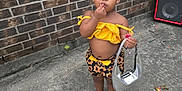 Jayden joined the competition — help win amazing prizes! accessory, barefoot, brick_wall, casual, child, concrete, cute, fashion, floral_shorts, headband, outdoor, person, purse, sidewalk, small_child, speaker, standing, summer, toddler, yellow_clothing