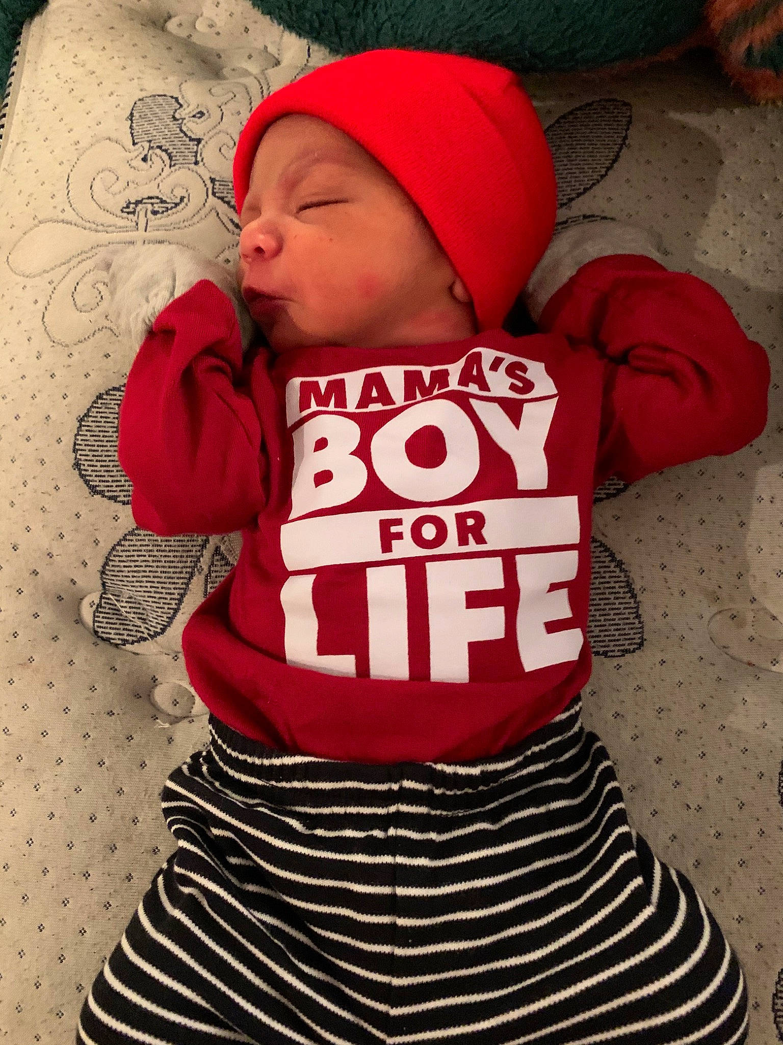 Antonio is registered to the contest to win money with this photo: baby, baby_toddler_clothing, child, cool, headgear, headwear, hoodie, outerwear, person, product, red, sleeve, t_shirt, toddler