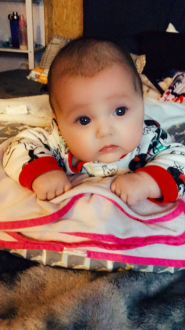 Alyvia is registered to the contest to win money with this photo: baby, baby_products, baby_toddler_clothing, bib, carmine, cheek, child, eyelash, fun, happy, human, iris, lip, nail, nose, person, sitting, skin, sweetness, toddler