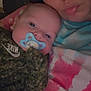 Jasper is registered to the contest to win money with this photo: baby, woman, pacifier, camo_clothing, close_up, selfie, heart_emoji, face, indoor, casual, skin, person, holding, expression, comfort, child, apparel, head, portrait, relaxation
